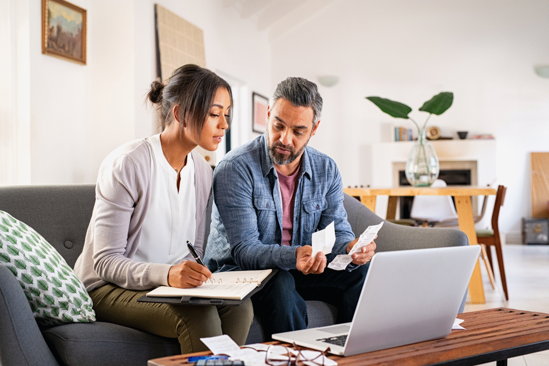 Couple in their living room crunching numbers
