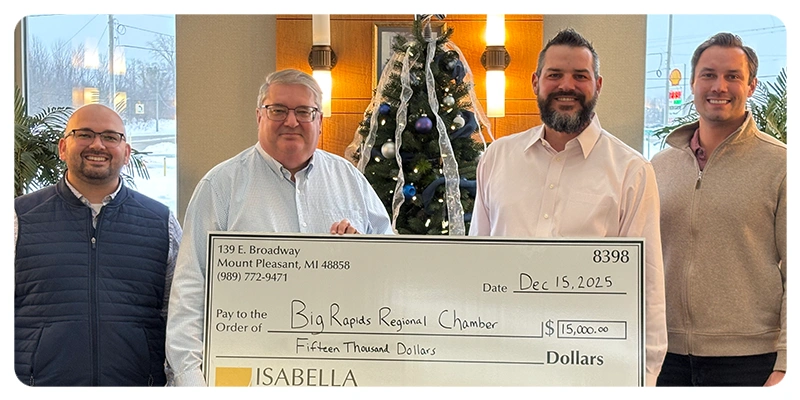 four men standing behind a large check with a donation to the Big Rapids Regional Chamber
