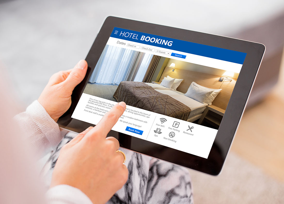 Person scrolling through tablet looking at hotel details on screen