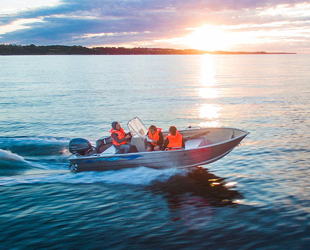 family boating together wearing life jackets