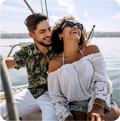 man and woman enjoying a boat ride together on a sunny day
