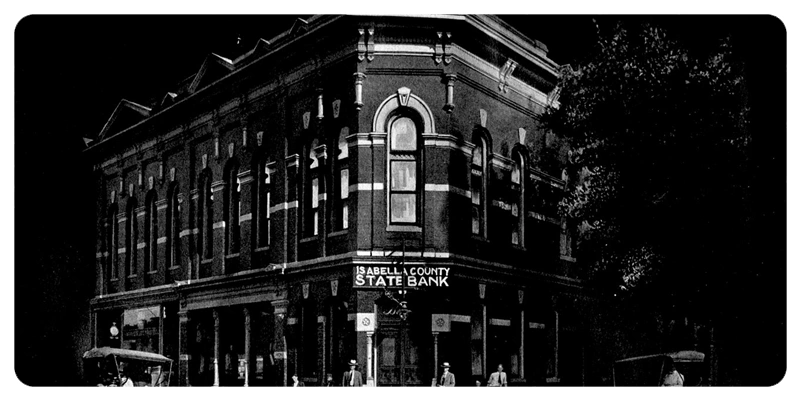 a brick building with an Isabella County State Bank sign
