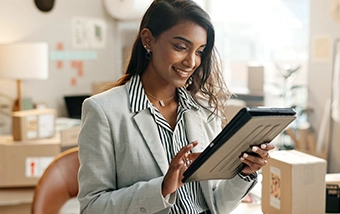 Woman smiling, working on a tablet
