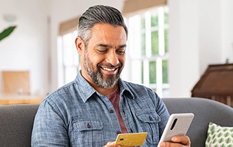 cardswap man holding debit card and phone