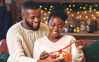 festive couple opening christmas presents