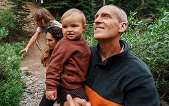 retired man with grandchild taking a hike outdoors