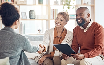 A couple speaking with an advisor