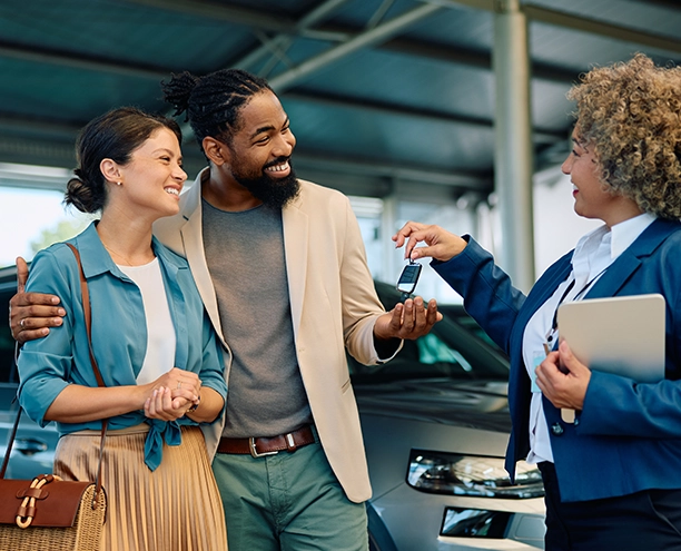 A couple at the dealership buying a new car