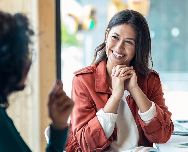 Woman smiling with her hands folded
