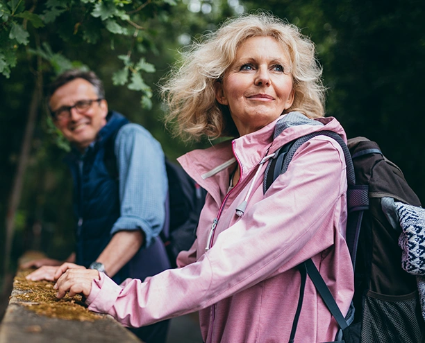 mature couple hiking looking hopeful for future