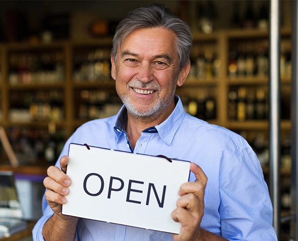 small business owner holding open sign