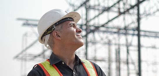 A construction worker looking into the distance