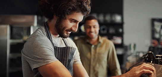 Cafe employee making coffee