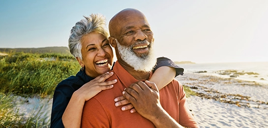 Couple smiling with arms around each other