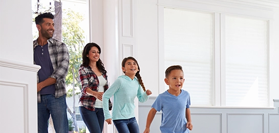 Family excitedly walking into a home