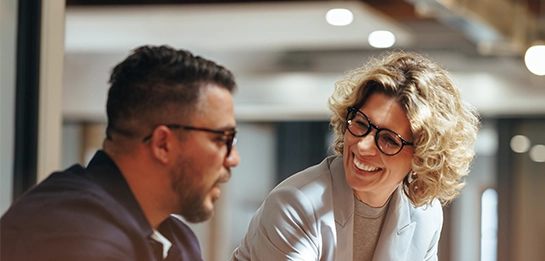 A man and woman having a conversation and smiling
