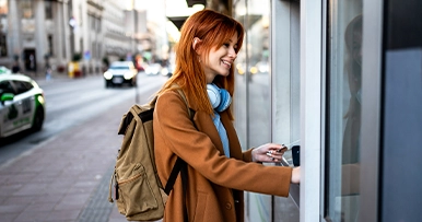 student using ATM to get cash from account