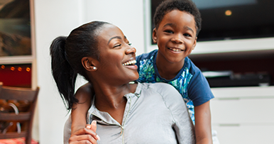 mother laughing with her child on the front porch