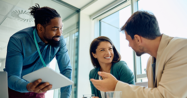 group of three coworkers discussing a project