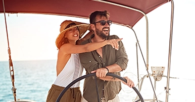 couple navigating and steering the boat