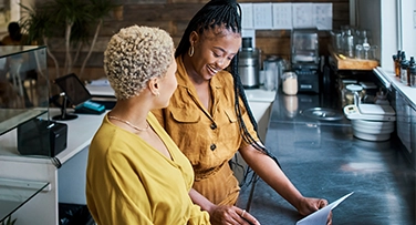 Store owners looking at a tablet together