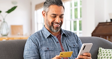 A man typing his card info into his phone