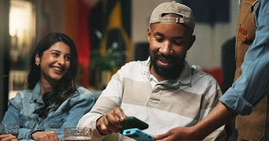 man paying a restaurant bill with a digital wallet on a smartphone