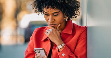 woman looking at her phone at a suspicous message