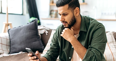man looking at his phone concerned about something he just read