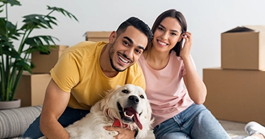 couple with their dog on moving day with boxes