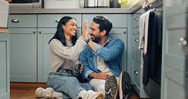 couple high-fiving after completing a kitchen renovation