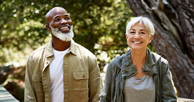 mature senior couple hiking in the woods together