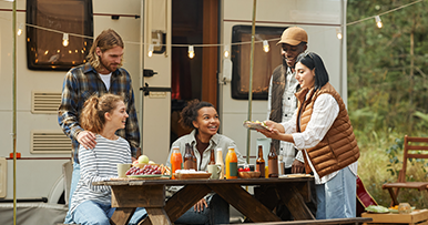 diverse family and friends camping with their recreational vehicle rv