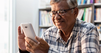 mature man using a mobile phone at home