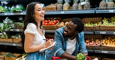 A young couple grocery shopping together